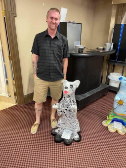 Artist Standing With Finished Sculpture 3- Paws on the Platte 2021