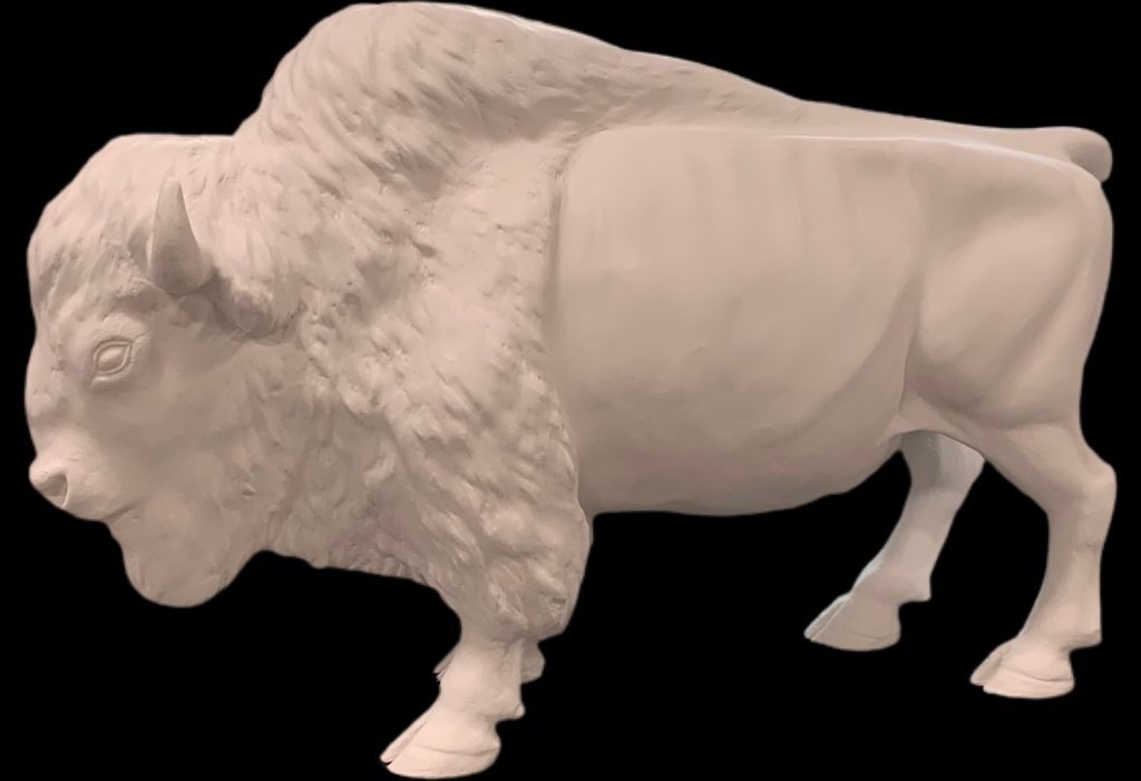 Small fiberglass bison sculpture with raised hump, side view, standing on all fours.