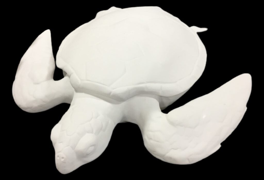 Overhead view of a white fiberglass sea turtle sculpture with outstretched flippers.