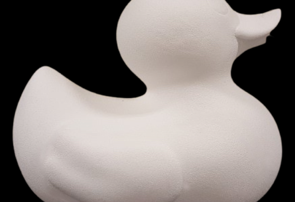 Large rubber duck fiberglass sculpture, side view, with smooth rounded body.